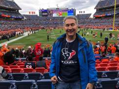 Michael wearing his Texans shirt with football field in background