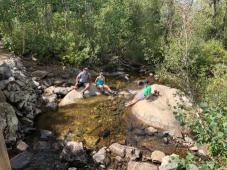 Mo, Bonnie and Zach taking a break on some big rocks in the creek